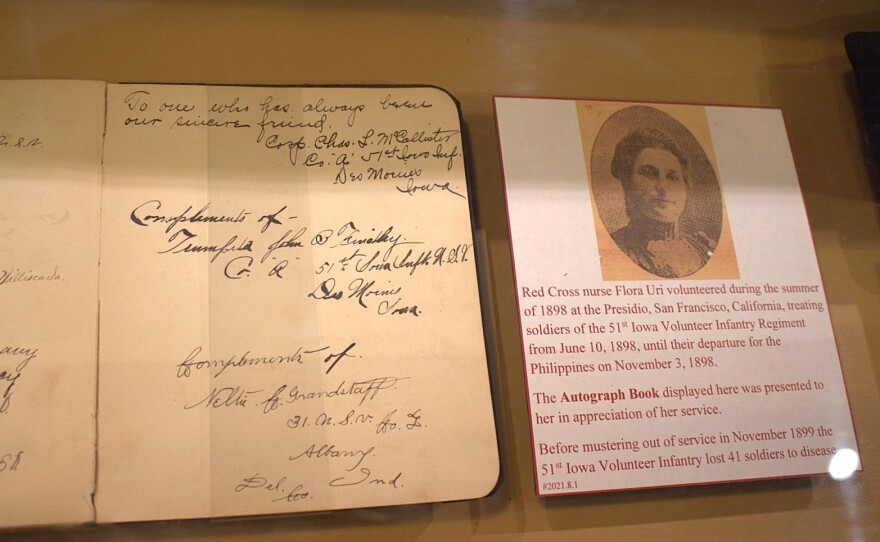 A display in a new exhibit at the Iowa Gold Star Military Museum that features a picture and story from a nurse, and the signed journal she was gifted.