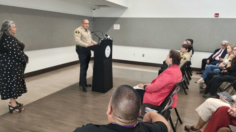 Bernalillo County Commission Chair Adriann Barboa, left, looks on as Bernalillo County Sheriff John Allen addresses those who attended a press conference on Wednesday announcing the proposed declaration, which will be aimed at expanding revocery services and treatment options.