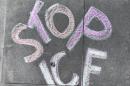 Chalk drawing of the words, “Stop ICE”, on the sidewalk, in front of SF immigration court.