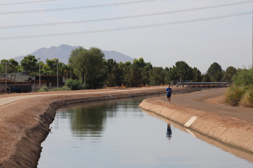 A man runs along the Eastern Canal in Gilbert, Arizona on August 26, 2026. The canal carries water from the Salt River Project. Those supplies are a major part of cities' response to smaller allocations from the Colorado River.