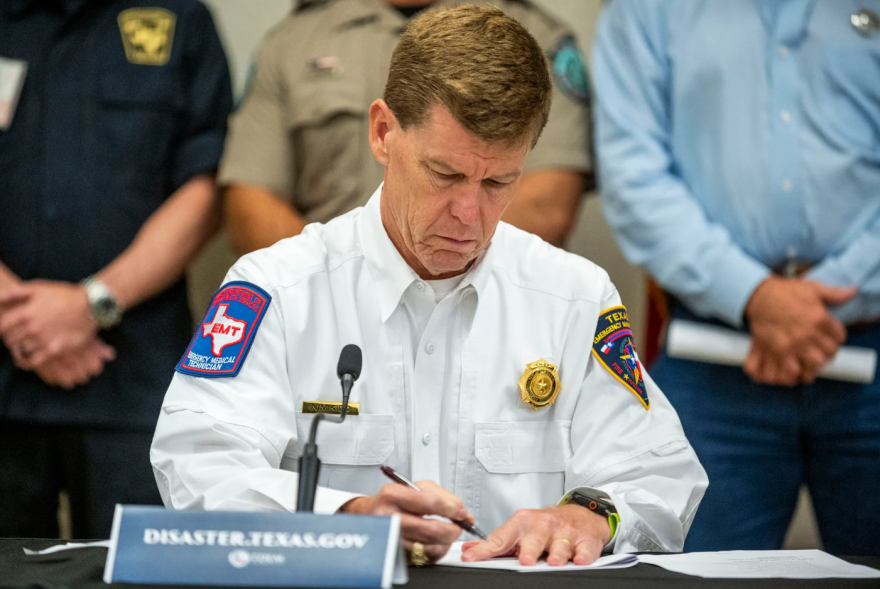 Nim Kidd, chief of the Texas Division of Emergency Management, takes notes during a press conference at Hill Country Youth Event Center on July 5, 2025 in Kerrville.