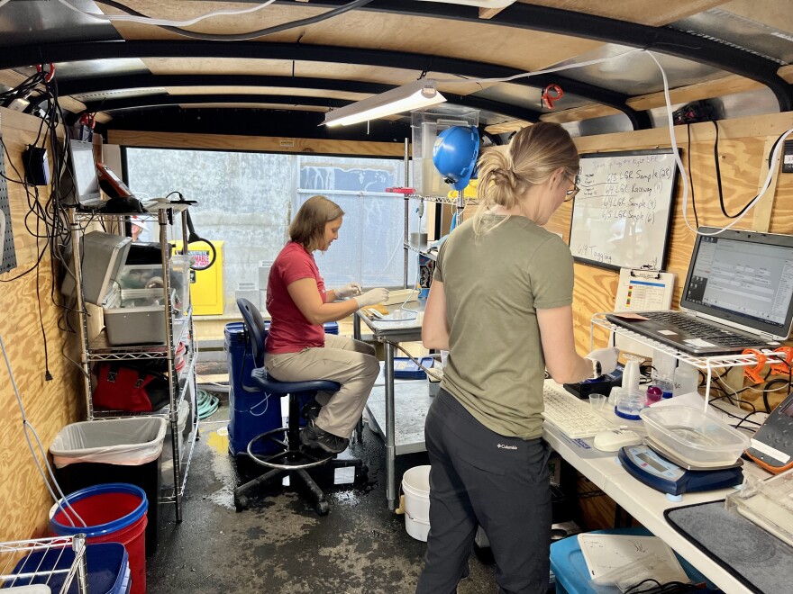  Scientists Jill Janak (right) and Kate Deters collect information and tag juvenile lamprey inside a trailer at Lower Granite Dam.