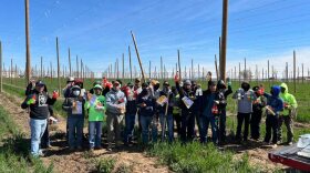Farmworkers in the Treasure Valley hold Heat and Relief Fund items from last year’s efforts. (Ricardo Godina/Idaho Immigrant Resource Alliance)