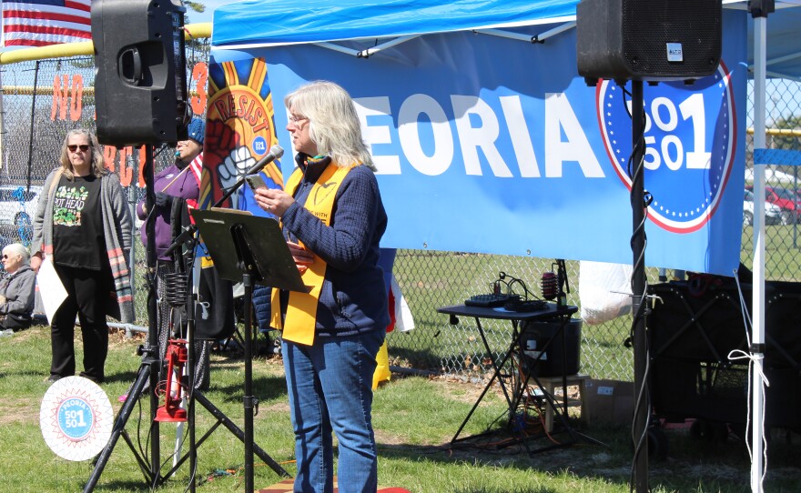 Jennifer Innis, minister with the Universalist Unitarian Church of Peoria, speaks to a crowd at the "No Kings" protest in Peoria.