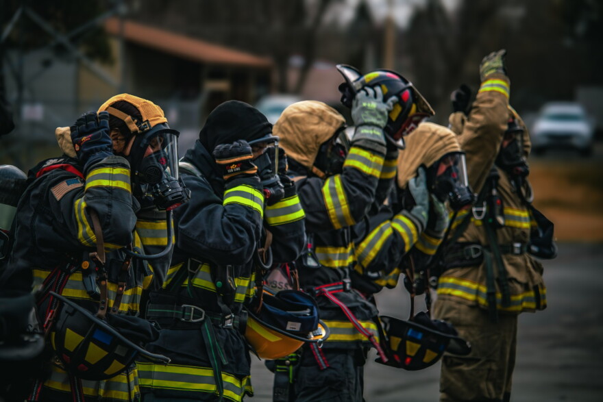 Firefighters don personal protective equipment during a training exercise outside Spokane County Fire District 9.