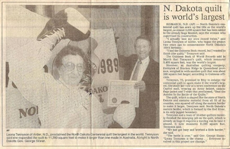 Newspaper clipping from 1989 picturing Leona Tennyson of Antler, ND, and North Dakota Governor George Sinner.