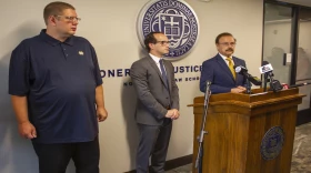 Andrew Royer, left, stands with his attorneys Elliot Slosar, center and Jimmy Gurule of the Notre Dame Law School. Royer received a $11.7 million settlement from the city of Elkhart in December 2023.