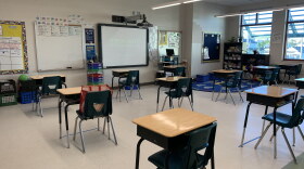 Kelli Gann's third grade classroom at Morris Jeff Community School. Desks are spaced more than six feet apart and students can see their virtual classmates projected on a screen at the front of the room.