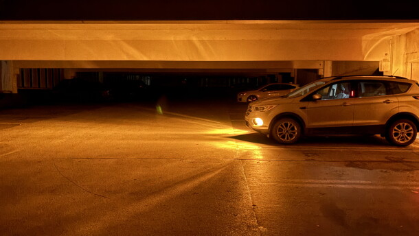 A vehicle’s headlights illuminate a dark parking garage on Michigan State University’s East Lansing campus during the widespread power outage Saturday night, Sept. 19, 2026.
