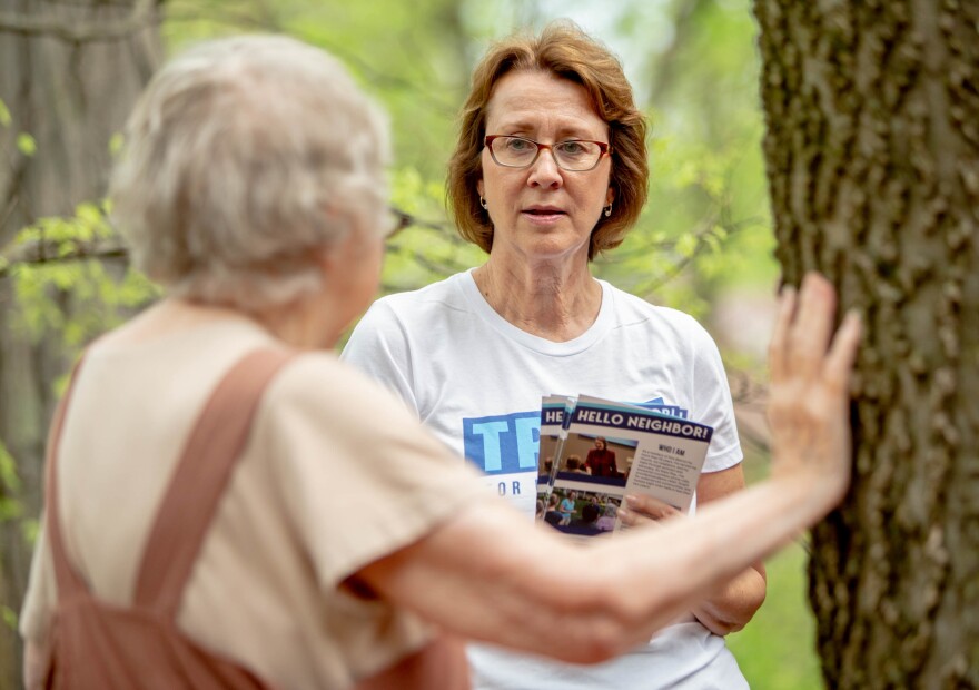 Trish Gunby, Democratic congressional candidate for MO-02, speaks to Mickie Dissett, 83, while canvassing for voter support in Glendale, Mo.