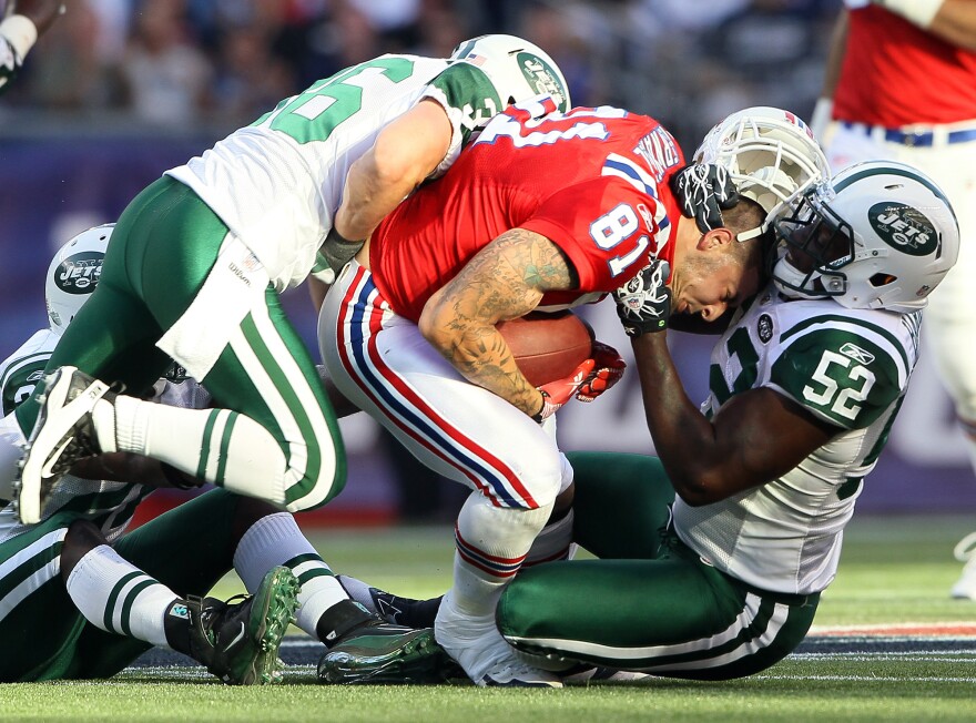 Aaron Hernandez (81), of the New England Patriots, lost his helmet during this play against the New York Jets in 2011. Hernandez killed himself in 2017, and researchers found that he had had one of the most severe cases of CTE ever seen in someone his age.