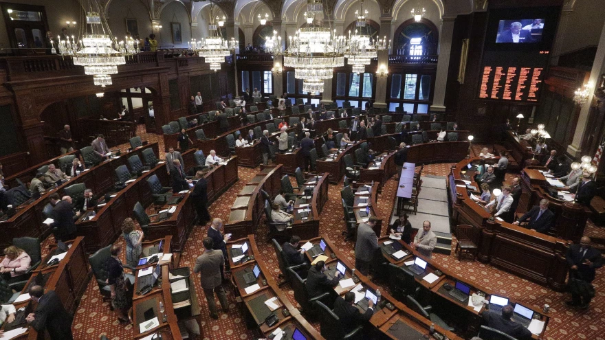 Illinois lawmakers listen to debate on the House floor during a session at the Illinois State Capitol.