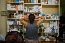 Laura Mendoza, who runs the “Medicine Is Not for Sale” community project, stands in front of a shelf stocked with medicine donated by humanitarian groups for free distribution in Havana, Cuba, Thursday, Oct. 8, 2026.