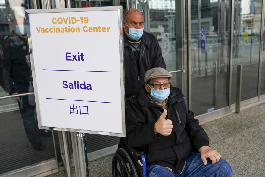 A senior citizen gives the thumbs up as he leaves a New York State COVID-19 vaccination site at the Jacob K. Javits Convention Center after receiving his first dose, Wednesday, Jan. 13, 2021, in New York. 
