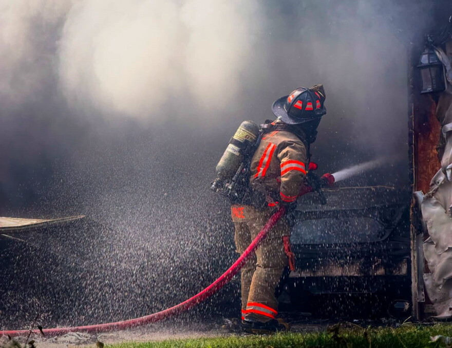 An Evansville firefighter sprays water on a blaze in the 1700 block of Southfield Road, during extreme heat Sept. 2, 2026