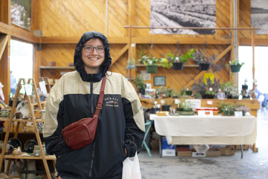 Amely Wernitz, who was visiting Fairbanks from Germany, shops around at the Tanana Valley Farmer's Market on July 9, 2025.