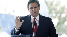 Florida Gov. Ron DeSantis speaks at a news conference at Universal Studios Wednesday, June 3, 2020, in Orlando, Fla. The Universal Studios theme park reopened today for season pass holders and will open to the general public on Friday. Bars and theme parks will be part of Florida's Phase 2 reopening after closure due to the coronavirus pandemic. (AP Photo/John Raoux)