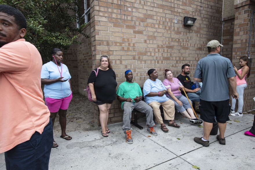 Hurricane evacuees relax Wednesday outside the temporary shelter at Trask Middle School in Wilmington, N.C., ahead of Florence's arrival.