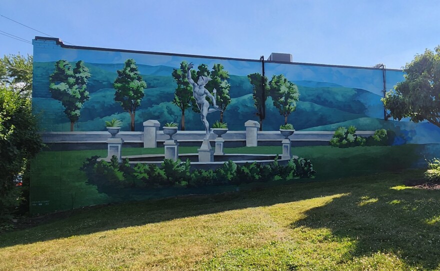 The former fountain at the Tripp House is shown on the mural.