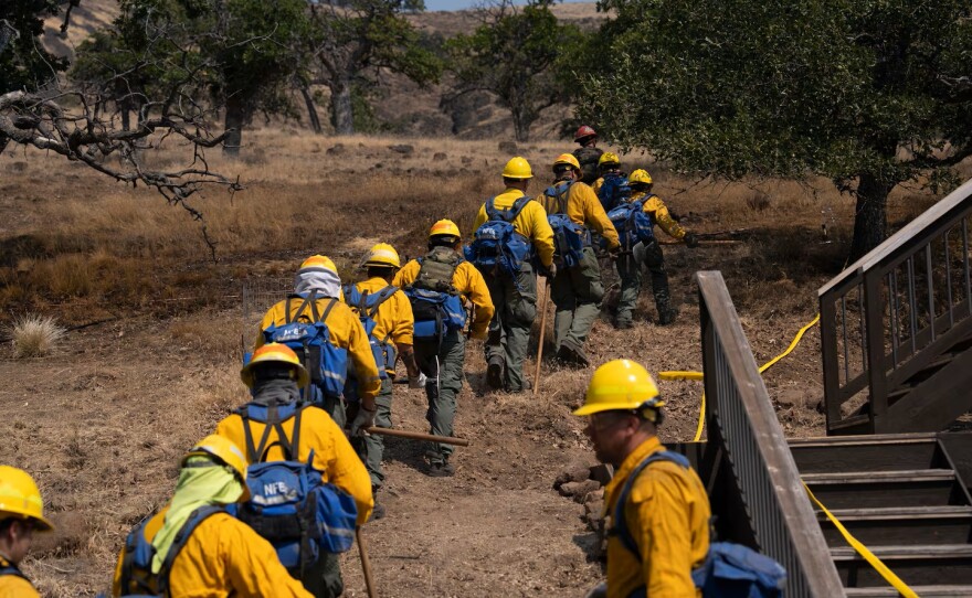 National Guard crews create fire lines around a home near Pine Hollow, Ore., on Aug 14, 2026.