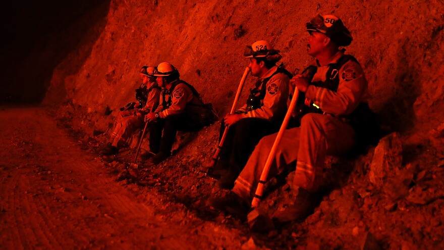 Firefighters monitor a back fire as they battle the Mendocino Complex Fire on Tuesday near Lodoga, Calif.