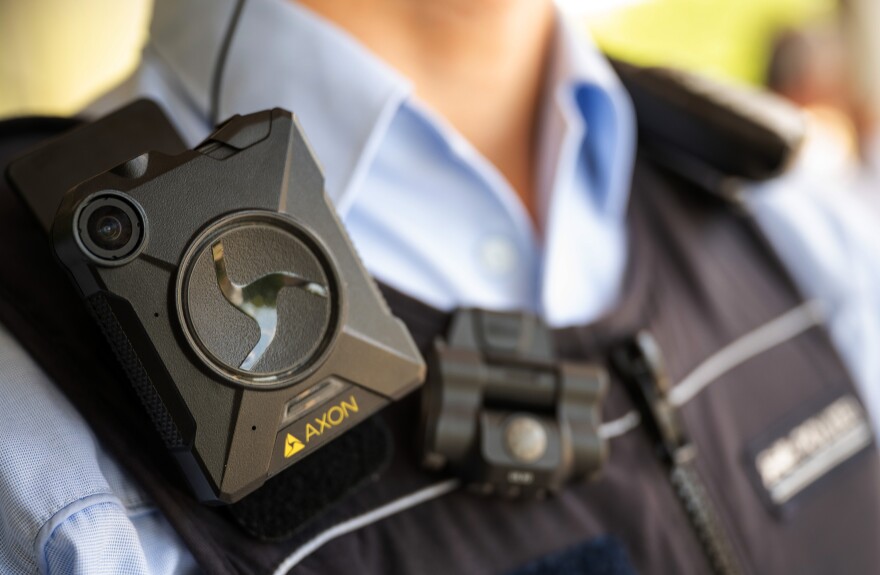 A police officer wearing an AXON body camera.