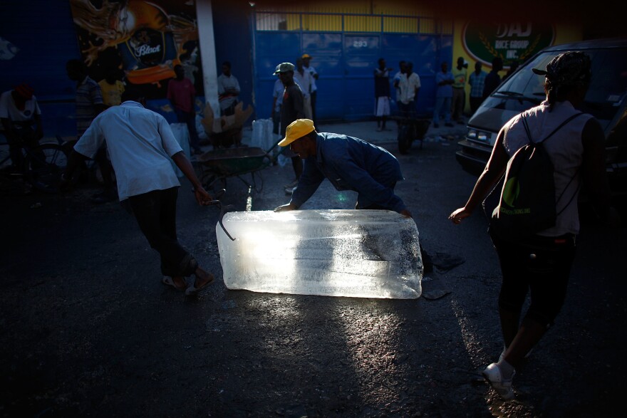 Men move blocks of ice to sell on the streets of Port-au-Prince. With the power still out, ice is the only way to cool and store any food.