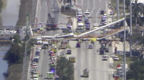 In this frame from video, emergency personnel work at the scene of a collapsed bridge in the Miami area, Thursday, March 15, 2018. (WPLG-TV via AP)