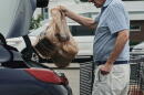 A person loads groceries in plastic bags into their vehicle, May 18, 2026, at a grocery store in Cincinnati. (Joshua A. Bickel/AP)
