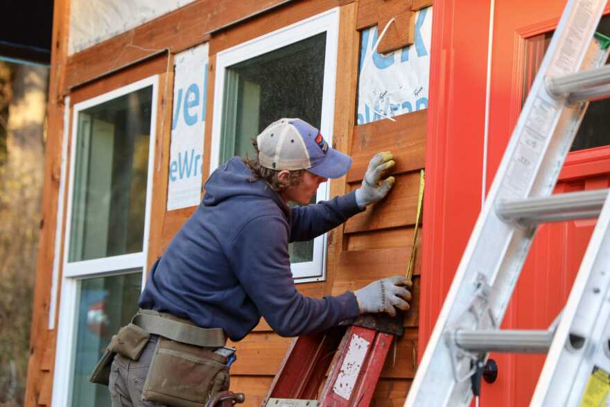 Juneau-Douglas High School: Yadaa.at Kalé senior Isaac Phelps measures cedar shingles during his house build class on Wednesday, Nov. 12, 2025.