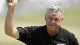 Northern Ireland's Darren Clarke acknowledges the crowd after putting on the 18th green in the second round of the British Open at Royal St. George's.