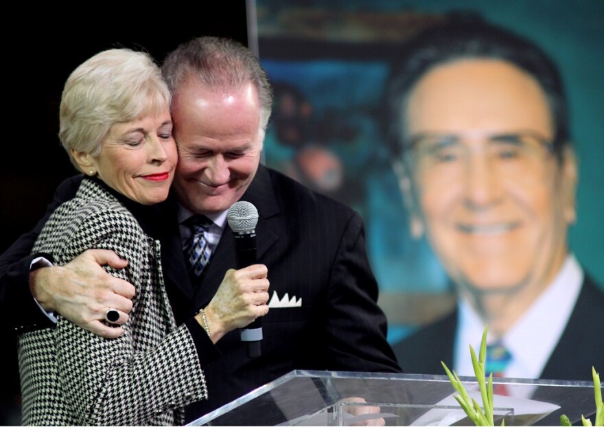 Roberta Potts and Richard Roberts share a tender moments as the eulogize their father, Oral Roberts.