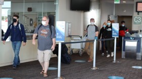 Travelers disembark a plane from Seattle at the Ted Stevens Anchorage International Airport on Friday, June 5, 2020. The airport was preparing for major changes to the state’s travel policy starting Saturday. (Tegan Hanlon/Alaska Public Media)