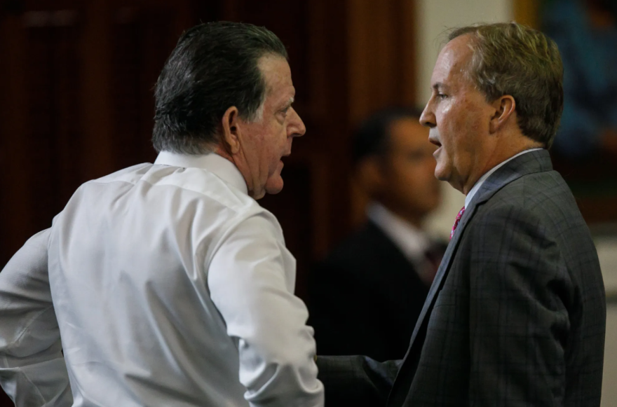Texas Attorney General Ken Paxton, right, speaks privately with defense attorney Dan Cogdell before starting the ninth day of his impeachment trial in the Senate Chamber at the Texas Capitol on Sept. 15, 2023, in Austin.