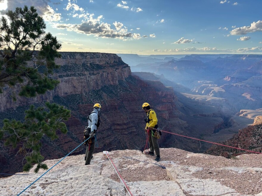 Search and rescue responders standing at the edge near the South Kaibab Trailhead on Sunday.