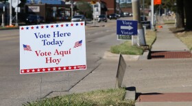 A sign with the message "Vote Here Today" is posted near the entrance to the Denton Civic Center parking lot.