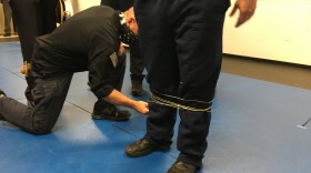 FOP President Dan Hils gets wrapped up by the BolaWrap which imobilizes suspects.