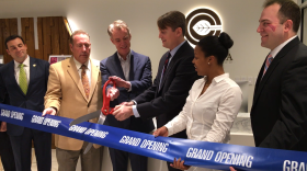 CEO Nick Vita and Executive Chairman Mike Abbott cut a ceremonial ribbon at the opening of their company's dispensary.