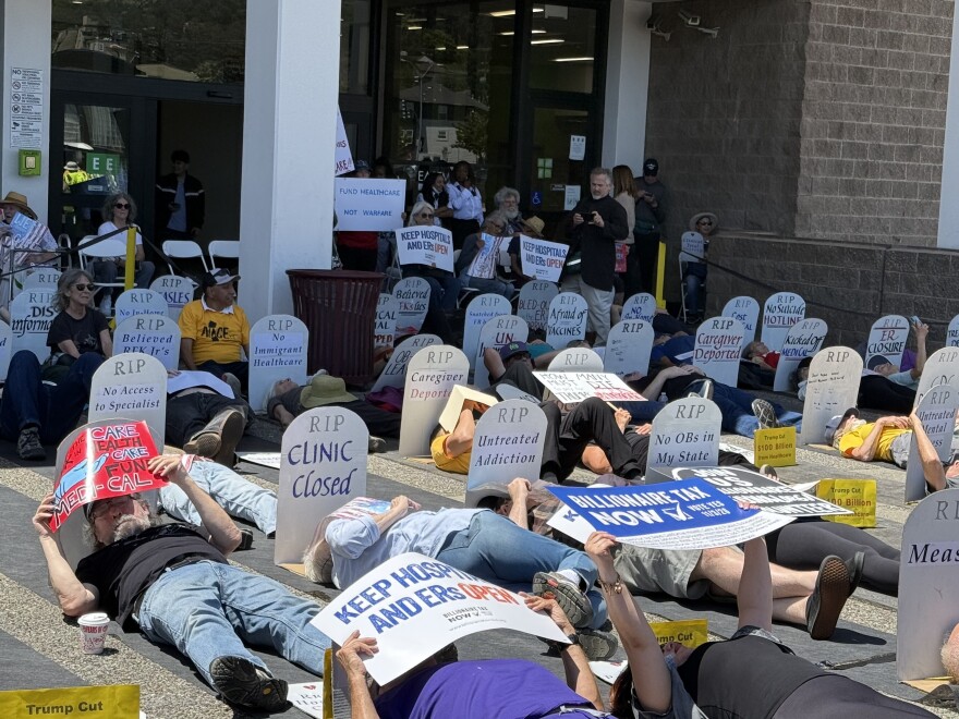 Dozens of East Bay residents and healthcare workers staged a ‘die-in’ on May 21, 2026 to protest the Trump administration’s sweeping federal healthcare cuts.