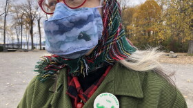 Andrea Anesi of Port Henry's Chamber of Commerce wears a homemade lake monster face mask and a Champ promotion pin from the 1980s. (Julia Press)