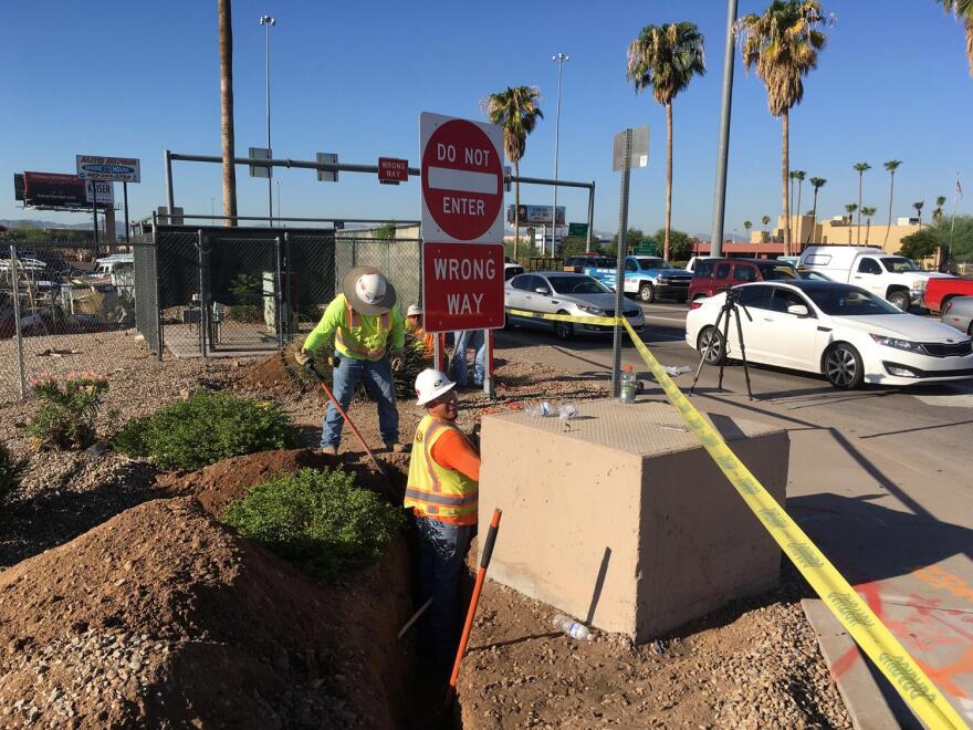 An ADOT crew performs initial trench work for the installation of thermal cameras along I-17.