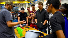 Jeremey Rorie shows Penn High School students what he does for work at B&B Molders in Mishawaka.