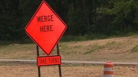 Signs along I-69 section 5 direct drivers to use both lanes during backups.