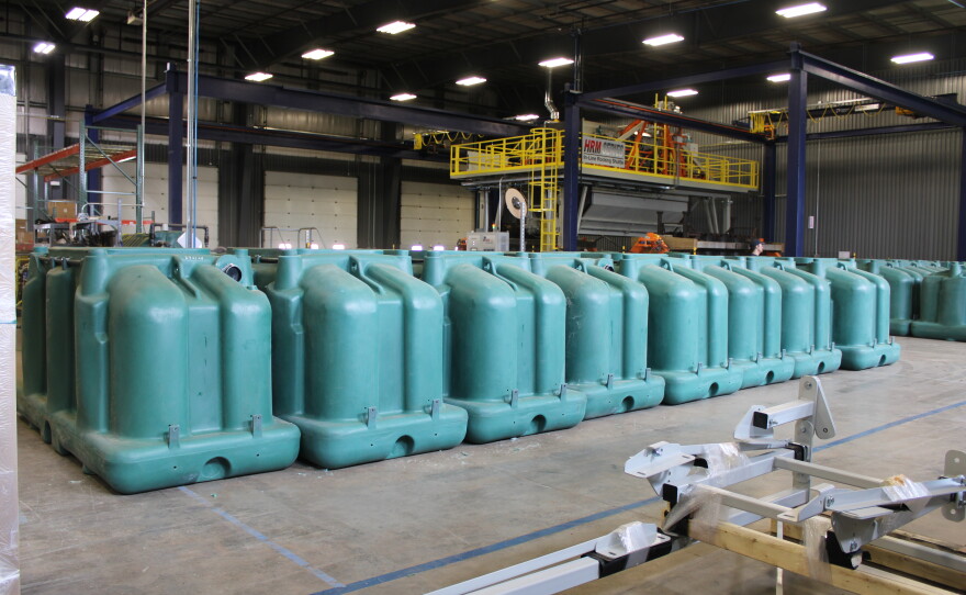 An aisle of polyethylene tanks that will be used for EcoFlow septic systems.