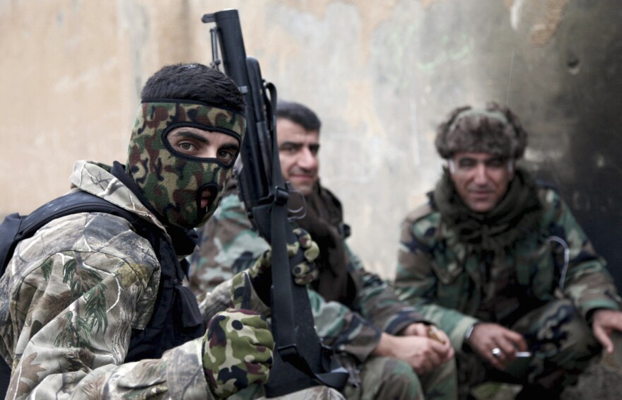 Kurdish peshmerga fighters rest on the outskirts of Mosul on Jan. 30.