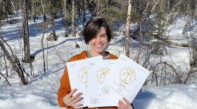 KDLG News Director Izzy Ross holds KDLG's 2022 awards