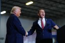 two men in suits shake hands