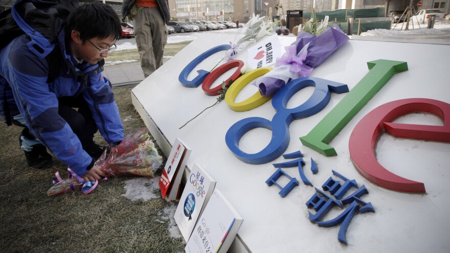 A man places flowers outside Google's Chinese headquarters in Beijing on Jan. 15, 2010. The tech giant's accusation that year that it had been hacked by China cast light on a problem few companies discuss: the pervasive threat from Chinese-based cybertheft.