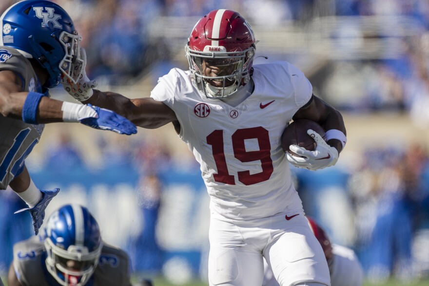Alabama wide receiver Kendrick Law (19) stiff arms Kentucky defensive back Ty Bryant (14) during the first half of an NCAA college football game in Lexington, Ky., Saturday, Nov. 11, 2023. (AP Photo/Michelle Haas Hutchins)