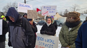 Demonstrators outside a Greater Cincinnati Tesla dealership protest proposed cuts to NIOSH and other federal agencies.
